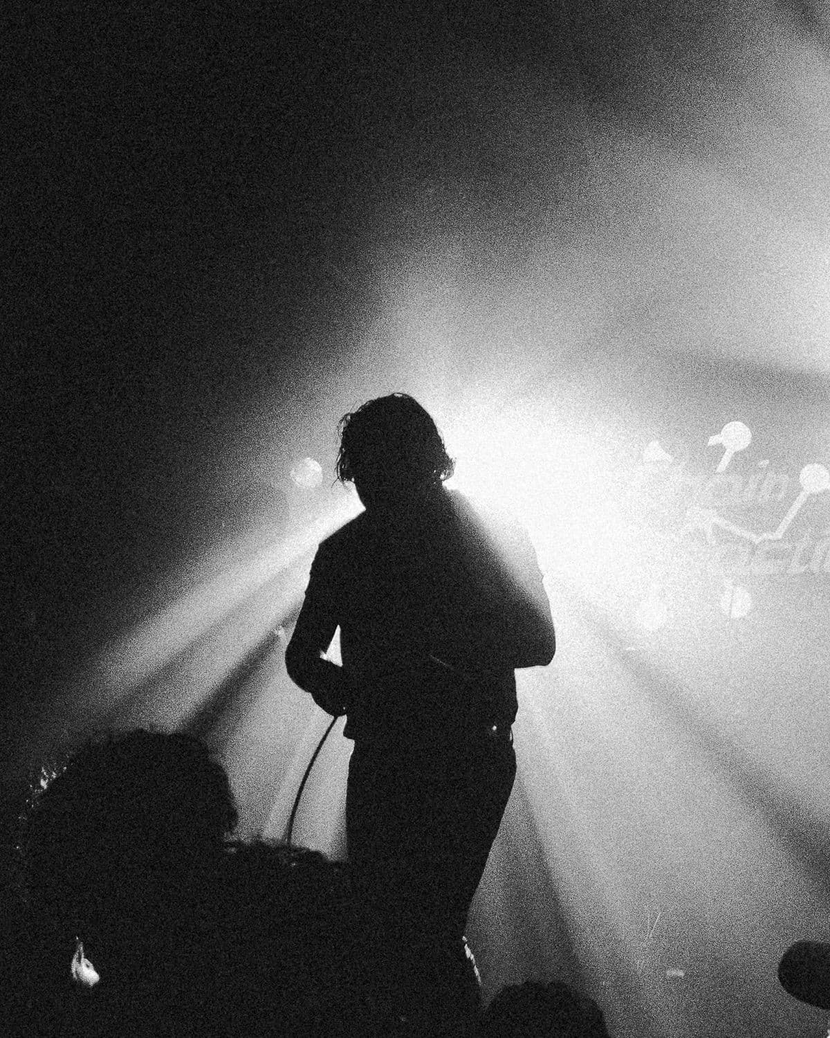 Bloodlines vocalist silhouetted in stage light at Chain Reaction