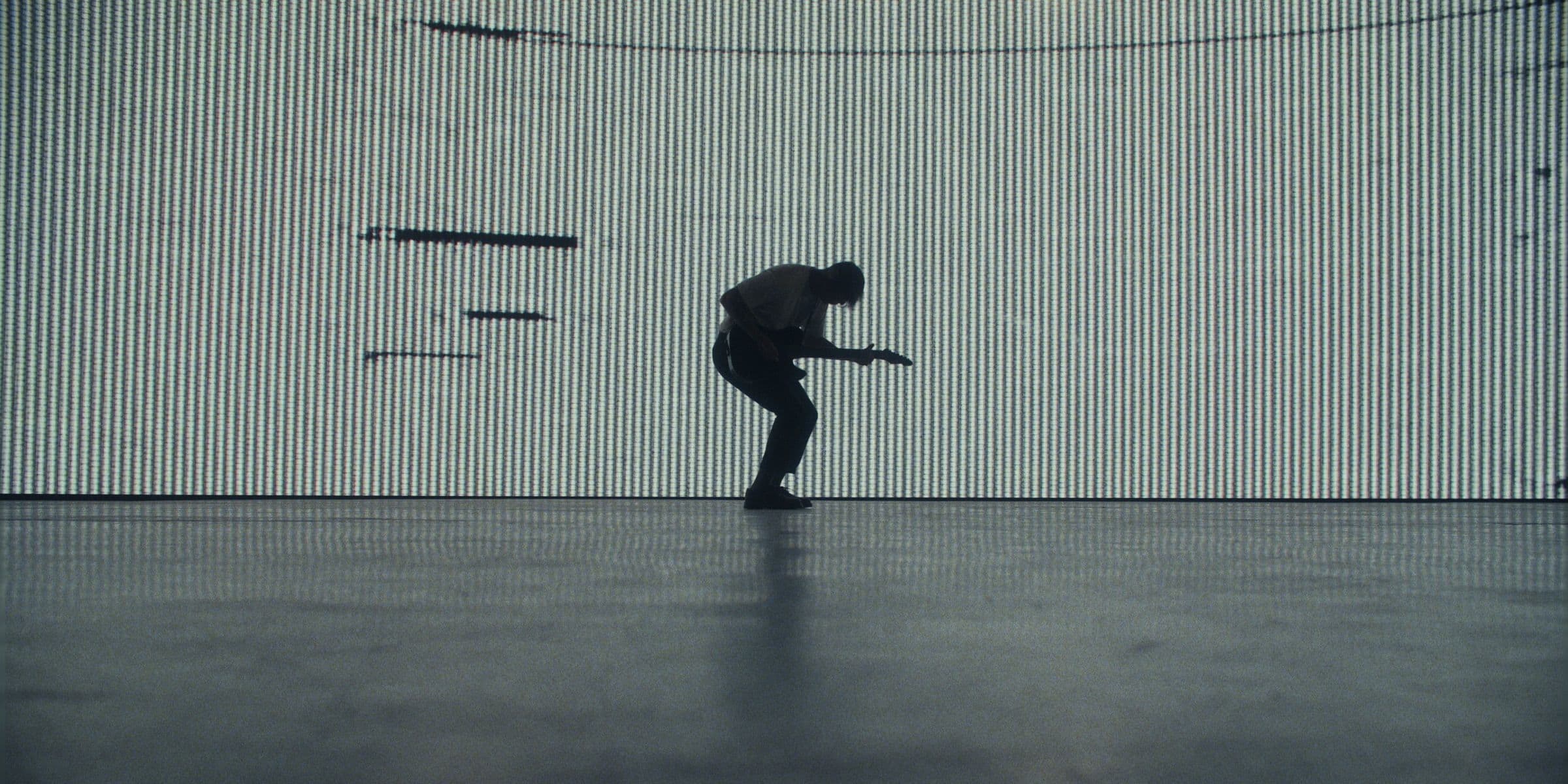 Bloodlines guitarist silhouetted against a white LED wall